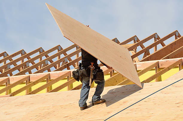 Construction crew working on the roof sheeting of a new, two story, commercial appartment building in Oregon